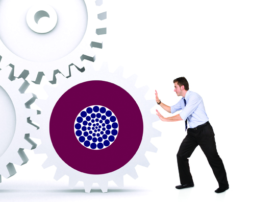 business man pushing a cogwheel