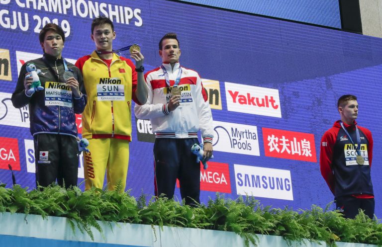 AP Photo, Duncan Scott, Sun Yang, Katsuhiro Matsumoto, Martin Malyutin,El británico medallista de bronce Duncan Scott, derecha, se niega a pararse junto al medallista de oro chino Sun Yang, segundo desde la izquierda, que muestra su medalla flanqueado por el japonés Katsuhiro Matsumoto, plata, a la izquierda, y el ruso Martin Malyutin, comedallista de bronce, tras la final de los 200 meros estilo libre en el Mundial de Natación en Gwangju, Corea dle Sur, el martes, 23 de julio del 2019.  (AP Foto/Lee Jin-man).